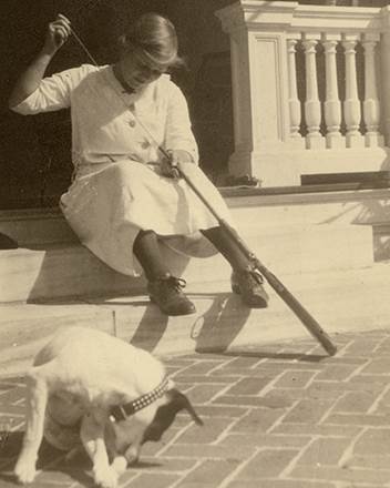 Young Peggy cleaning a gun at Hildene