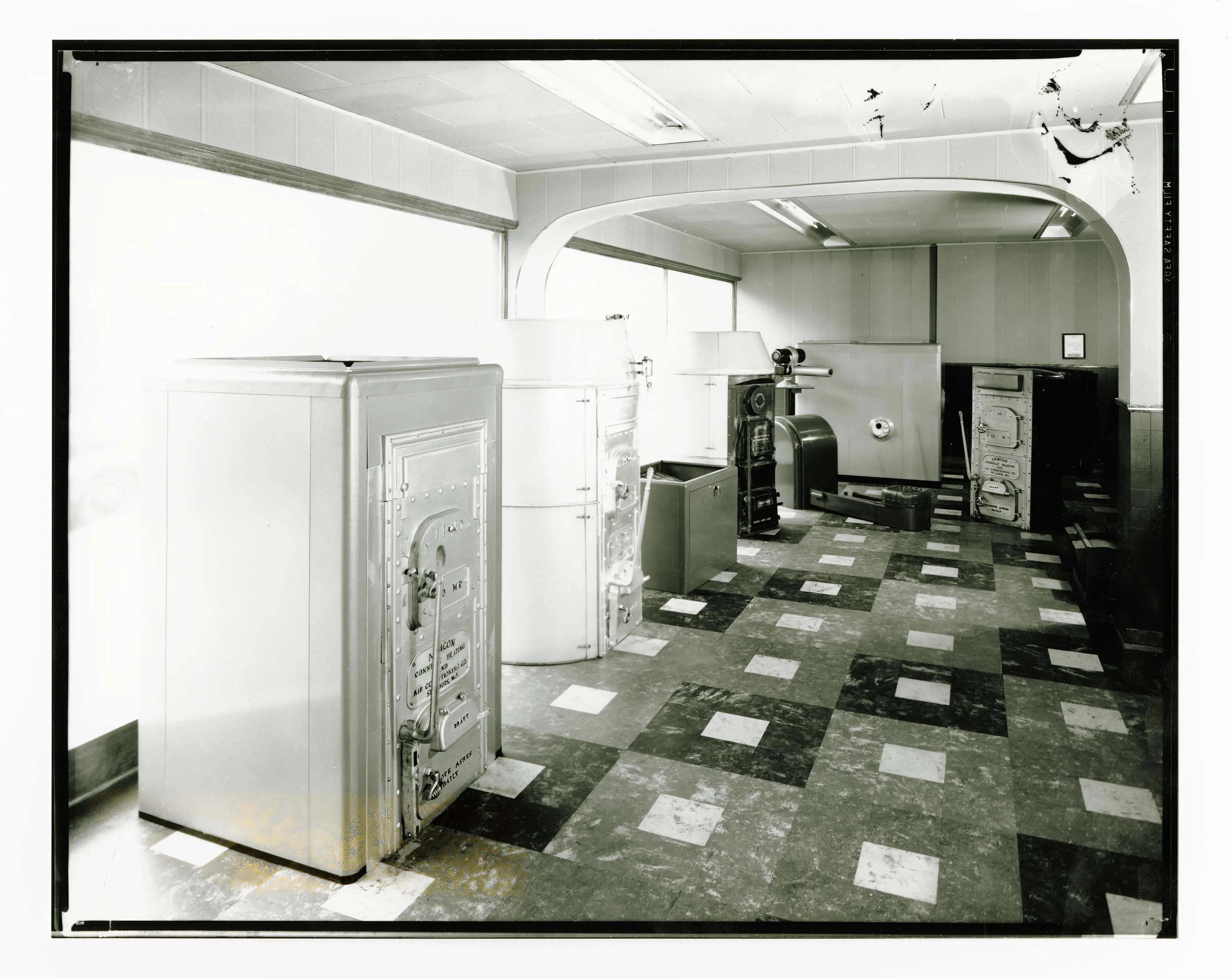 A black-and-white photo of a store's showroom displaying several large air conditioning units