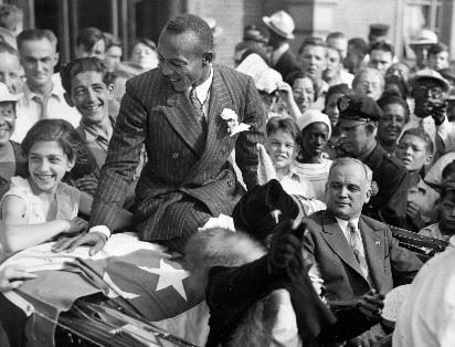 Jesse Owens upon his return to Cleveland, Ohio, celebrating his success in Berlin. (Central Press Association 1936)