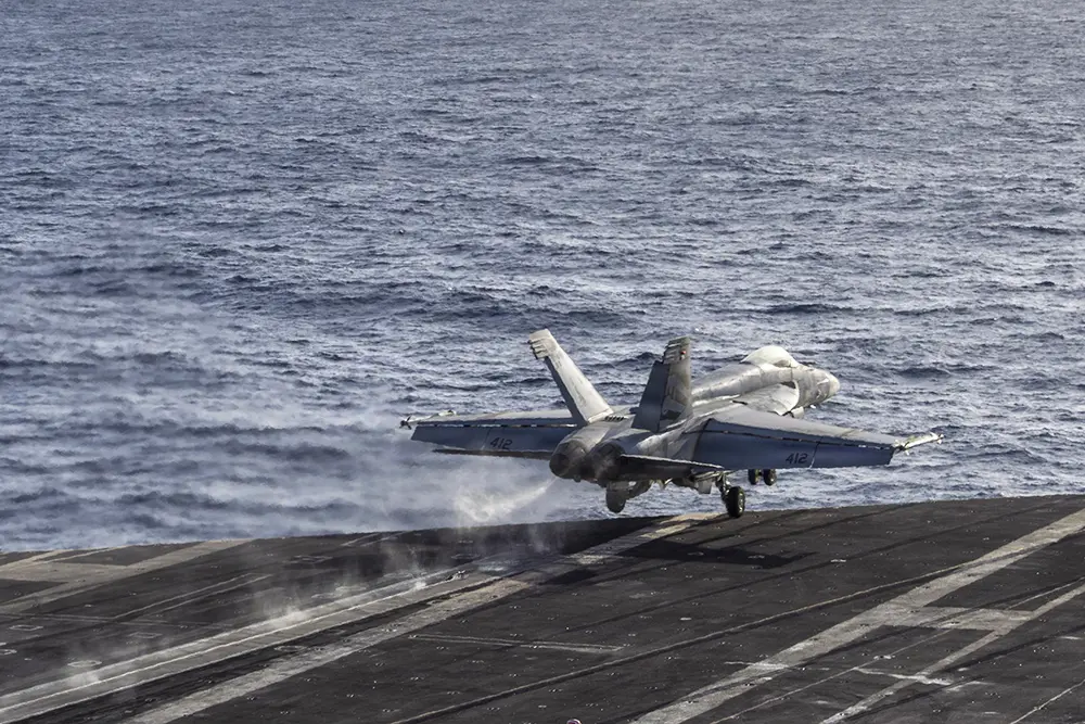 Photo of a jet plane taking off from an aircraft carrier