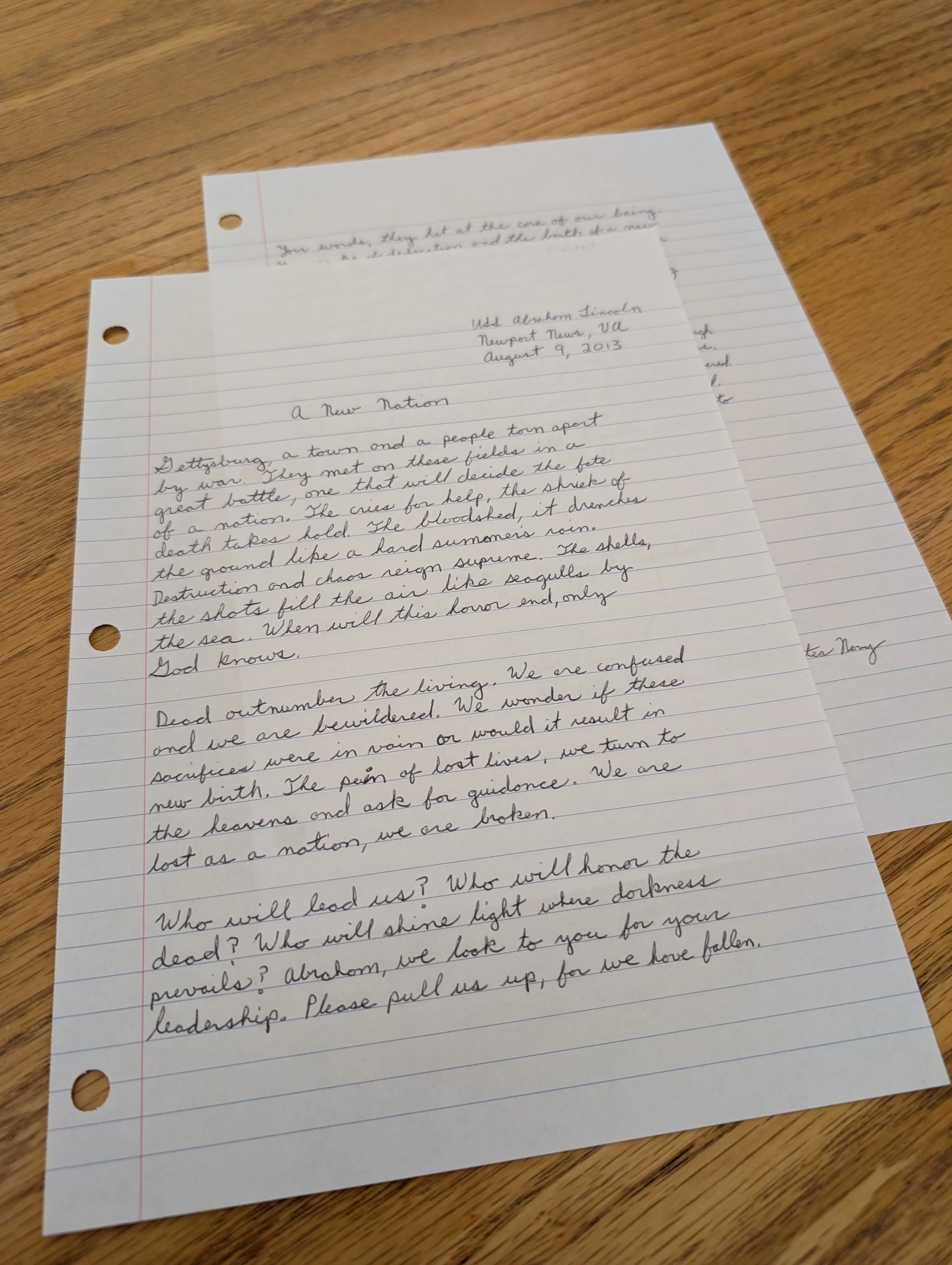 Two sheets of lined paper covered in handwriting