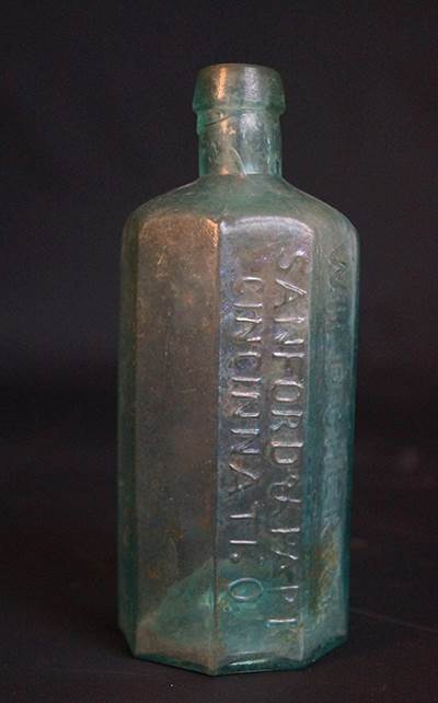 A similar bottle but more crudely made and in worse condition.